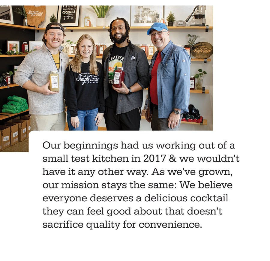 Four team members smiling and holding mixer bottles inside Simple Times Mixers retail space with product shelves behind them