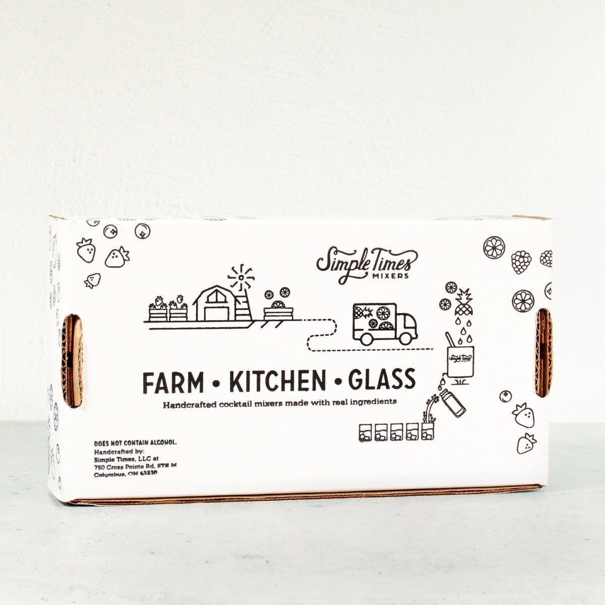 Front view of Fan Favorite four-pack cocktail mixer gift box showing illustrated Simple Times farm, kitchen, and bar packaging