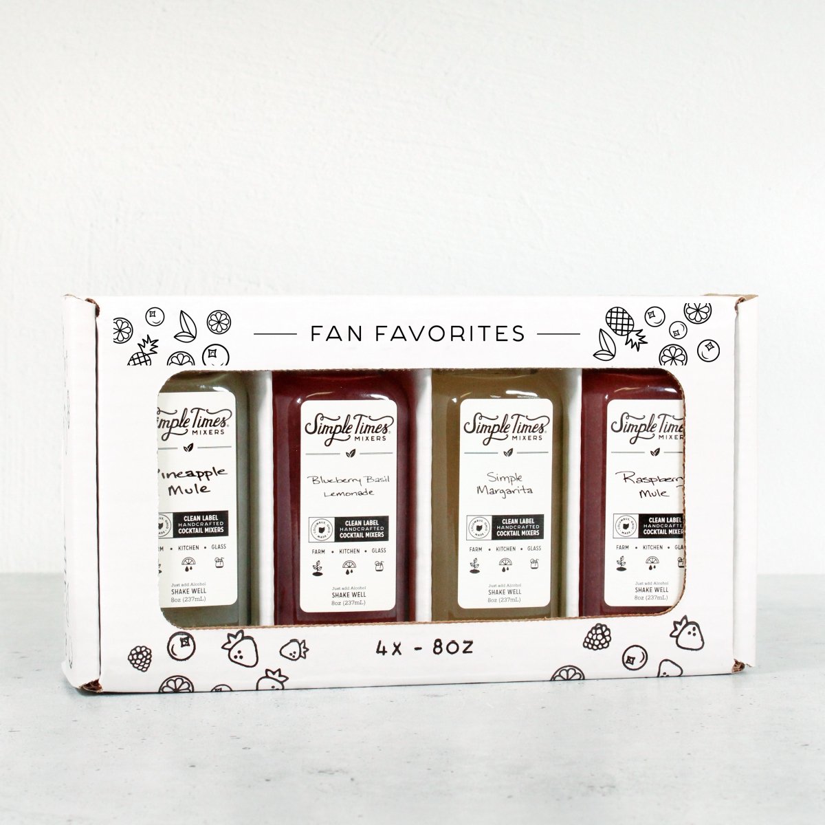 Front view of Fan Favorite 4-Pack showcasing four 8-ounce cocktail mixer bottles in a gift box on a white background