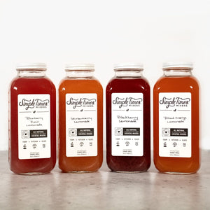 Front view of Lemonade Bundle with four flavored lemonade mixer bottles on a light background