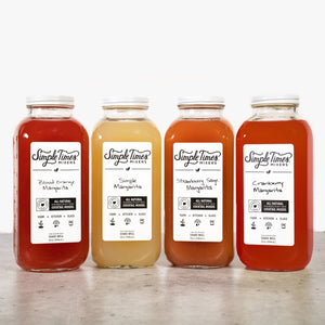 Front view of Margarita Bundle with four 32-ounce bottles in Simple, Cranberry, Strawberry Sage, and Blood Orange flavors