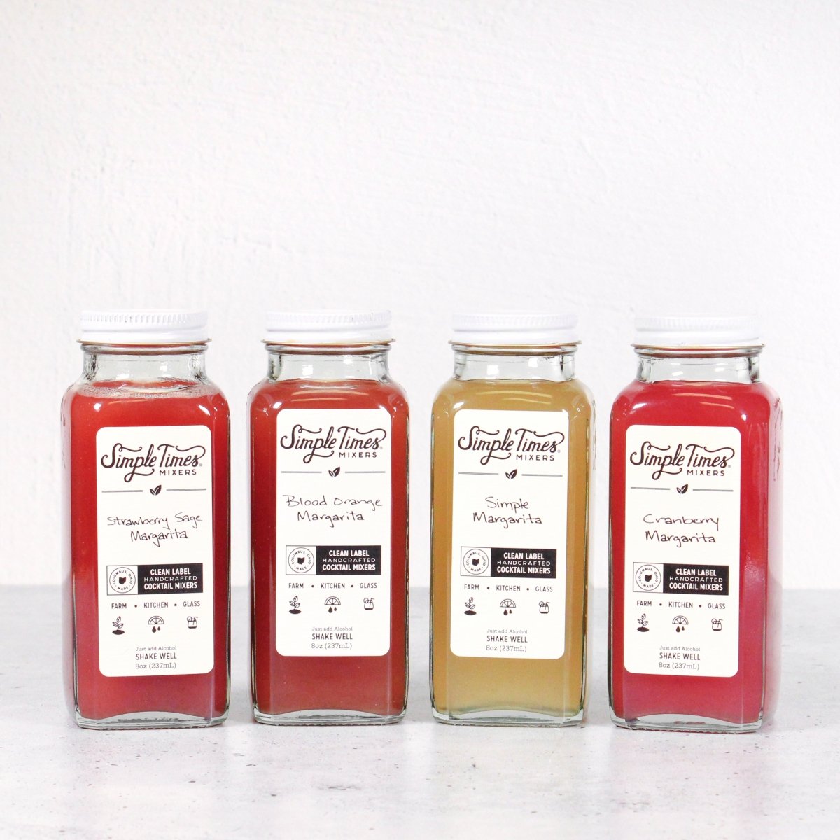 Front view of Margarita Madness 4-Pack showing four 8 ounce cocktail mixer bottles on a white background