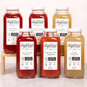 Front view of Margarita Variety 6-Pack showcasing six mixer bottles in red, pink, and golden hues on a white background