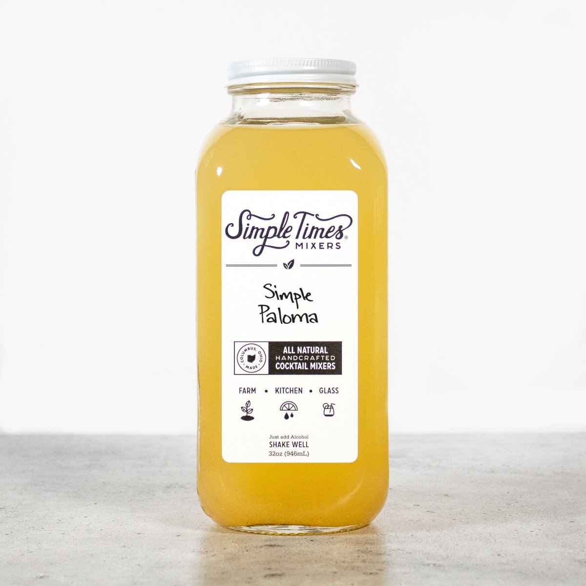 Front view of Simple Paloma cocktail mixer bottle showcasing its yellow grapefruit and lime blend on a light gray surface