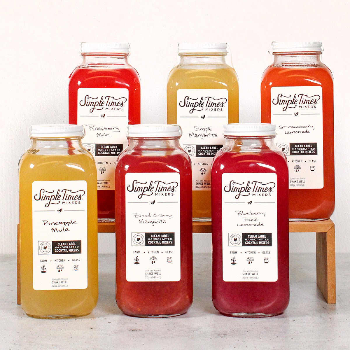 Front view of Summer Variety 6-Pack showcasing six colorful cocktail mixer bottles arranged in two rows on a light background