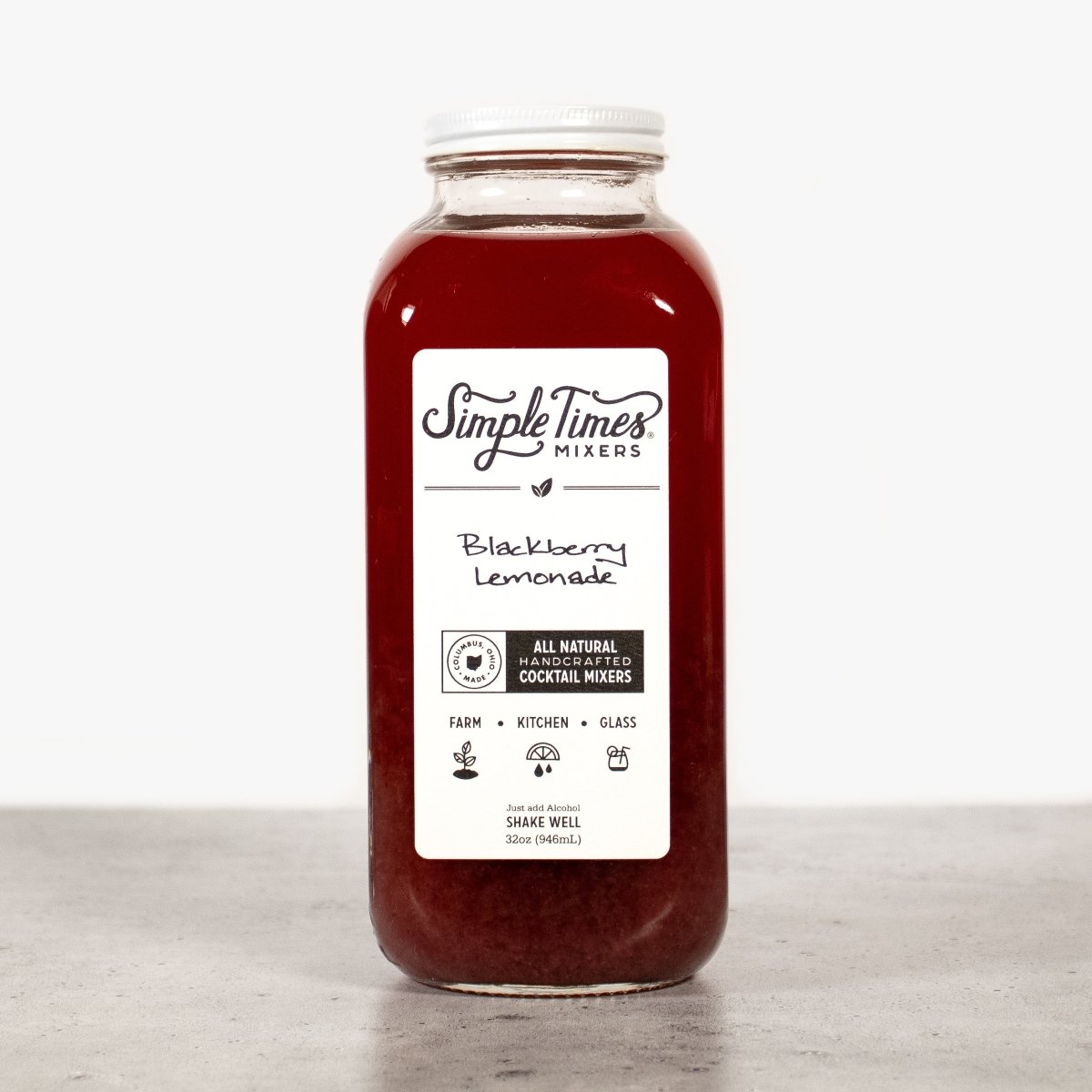 Front view of a 32 oz Blackberry Lemonade cocktail mixer bottle showcasing its dark berry color on a neutral surface