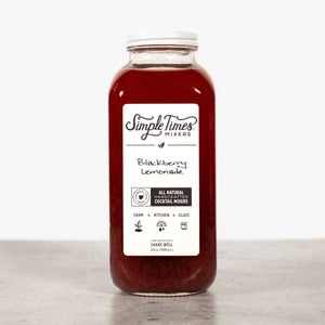 Front view of a 32 oz Blackberry Lemonade cocktail mixer bottle showcasing its dark berry color on a neutral surface