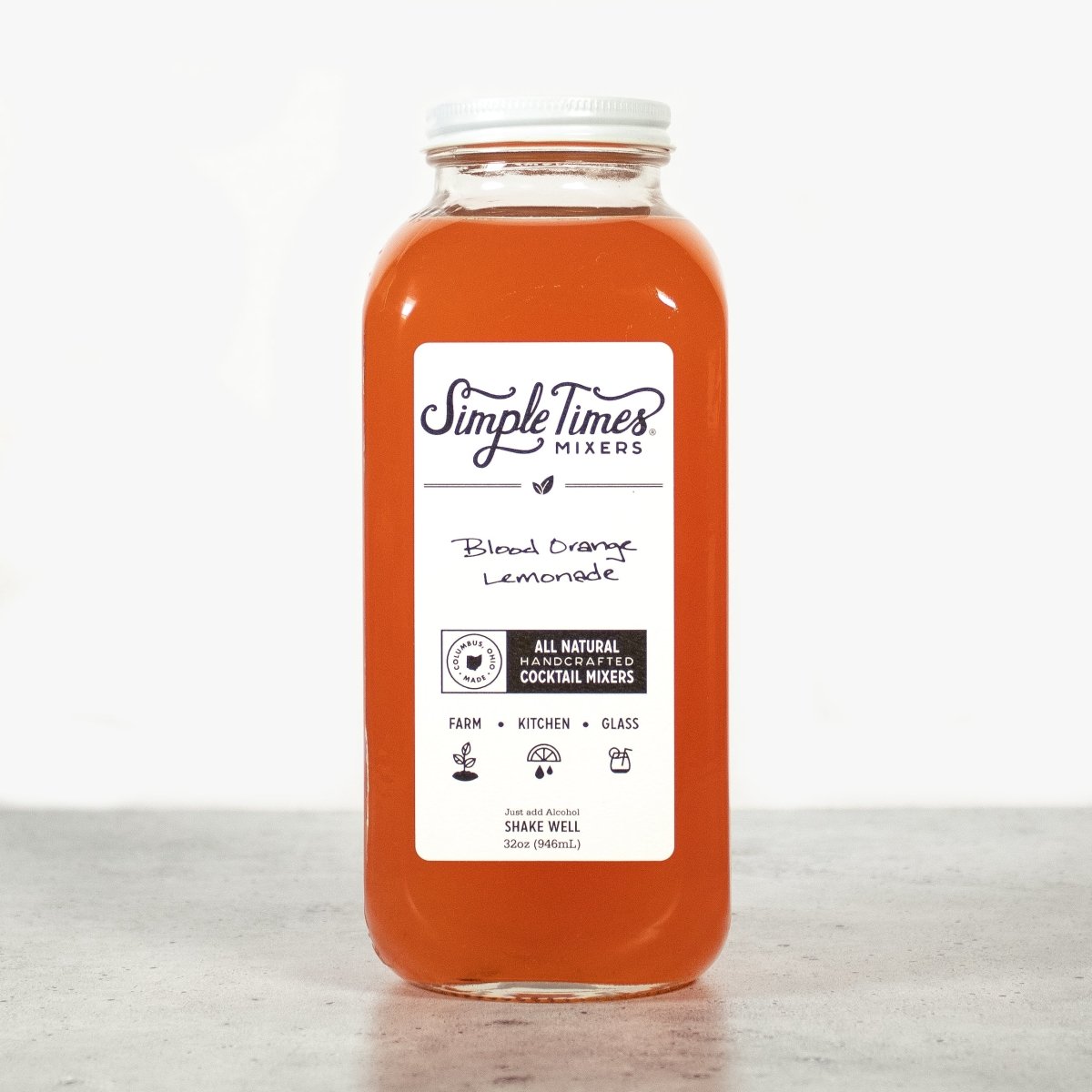 Front view of Blood Orange Lemonade cocktail mixer bottle showcasing its orange color with a light background
