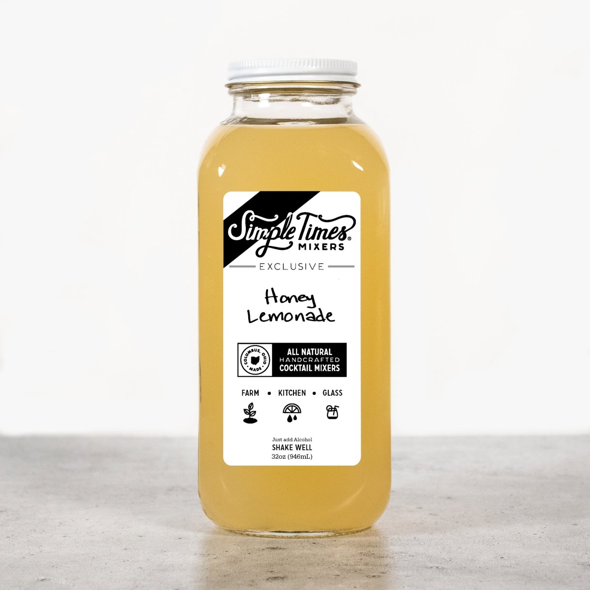 Front view of Honey Lemonade cocktail mixer bottle showcasing its golden color and product label on a light background