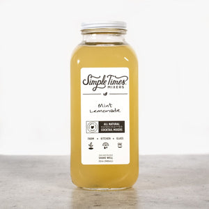 Front view of Mint Lemonade in a 32 ounce bottle with a white label on a light gray surface