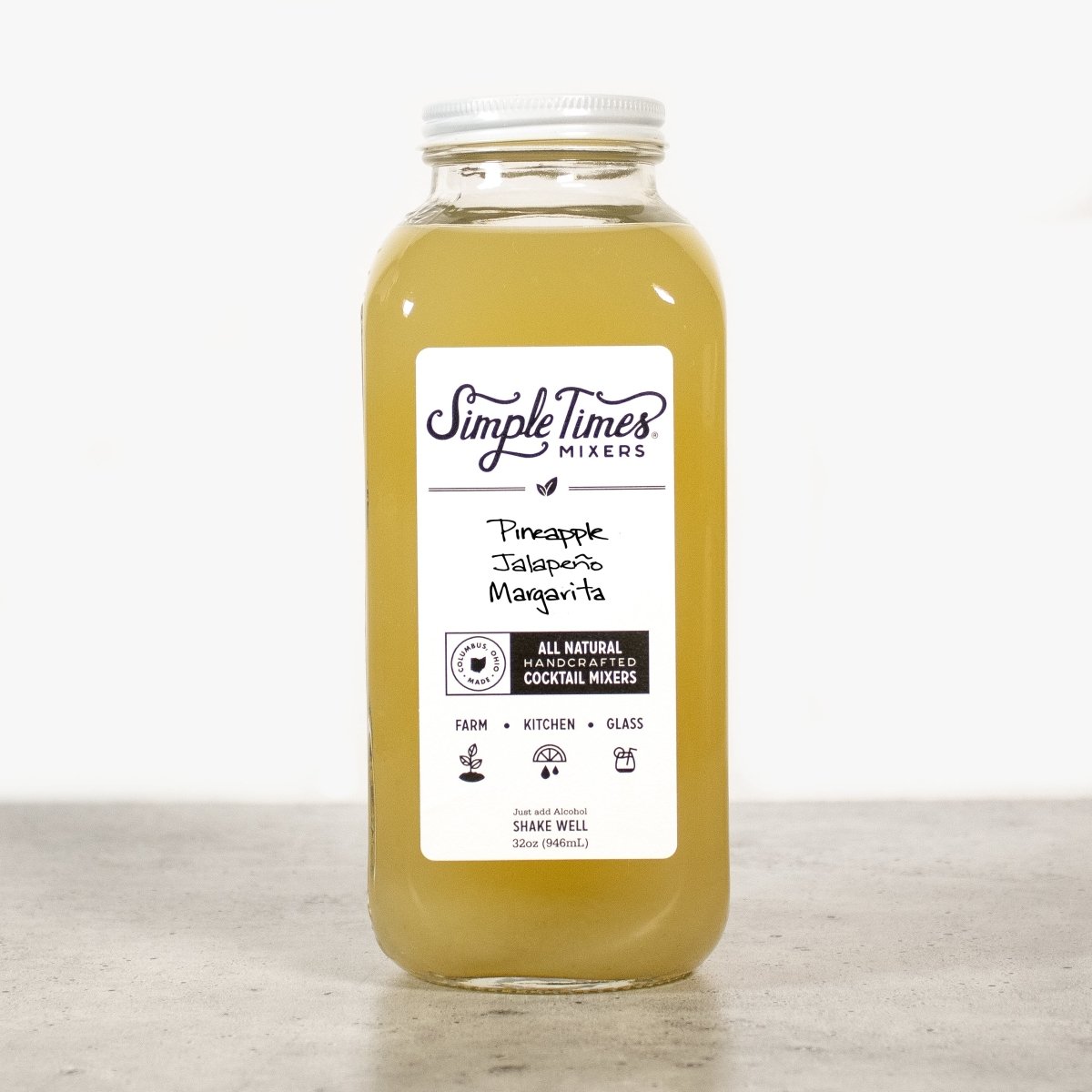 Front view of Pineapple Jalapeño Margarita cocktail mixer showcasing its 32-ounce bottle and white label on a light background