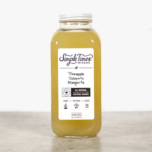 Front view of Pineapple Jalapeño Margarita cocktail mixer showcasing its 32-ounce bottle and white label on a light background
