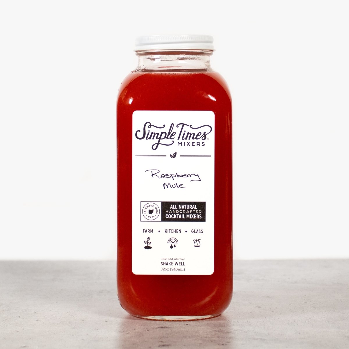 Front view of Raspberry Mule cocktail mixer bottle showcasing red mixer in a clear bottle on a light background