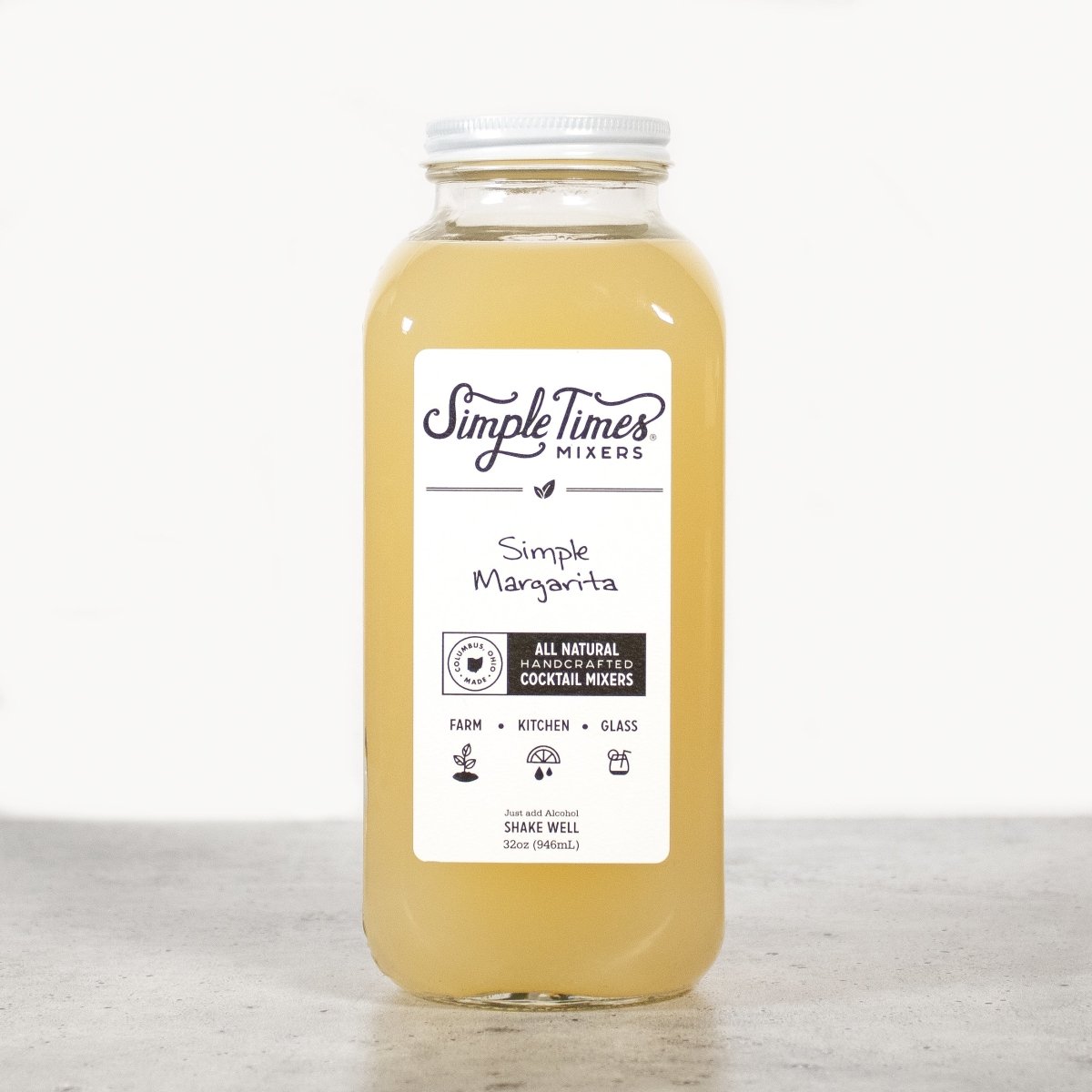 Front view of Simple Margarita cocktail mixer showcasing its yellow color and labeled glass bottle on a white background