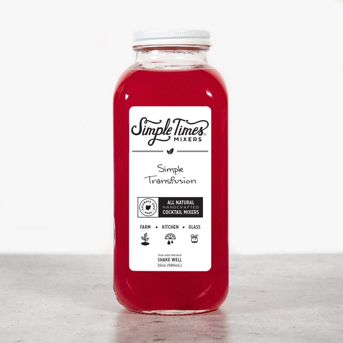 Front view of Simple Transfusion cocktail mixer in a red 32-ounce bottle showcasing its label against a light gray background