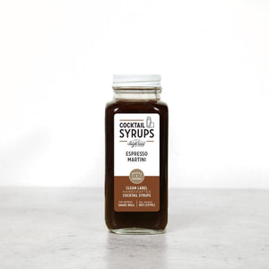 Front view of Espresso Martini cocktail syrup bottle showing label and dark brown syrup on white background